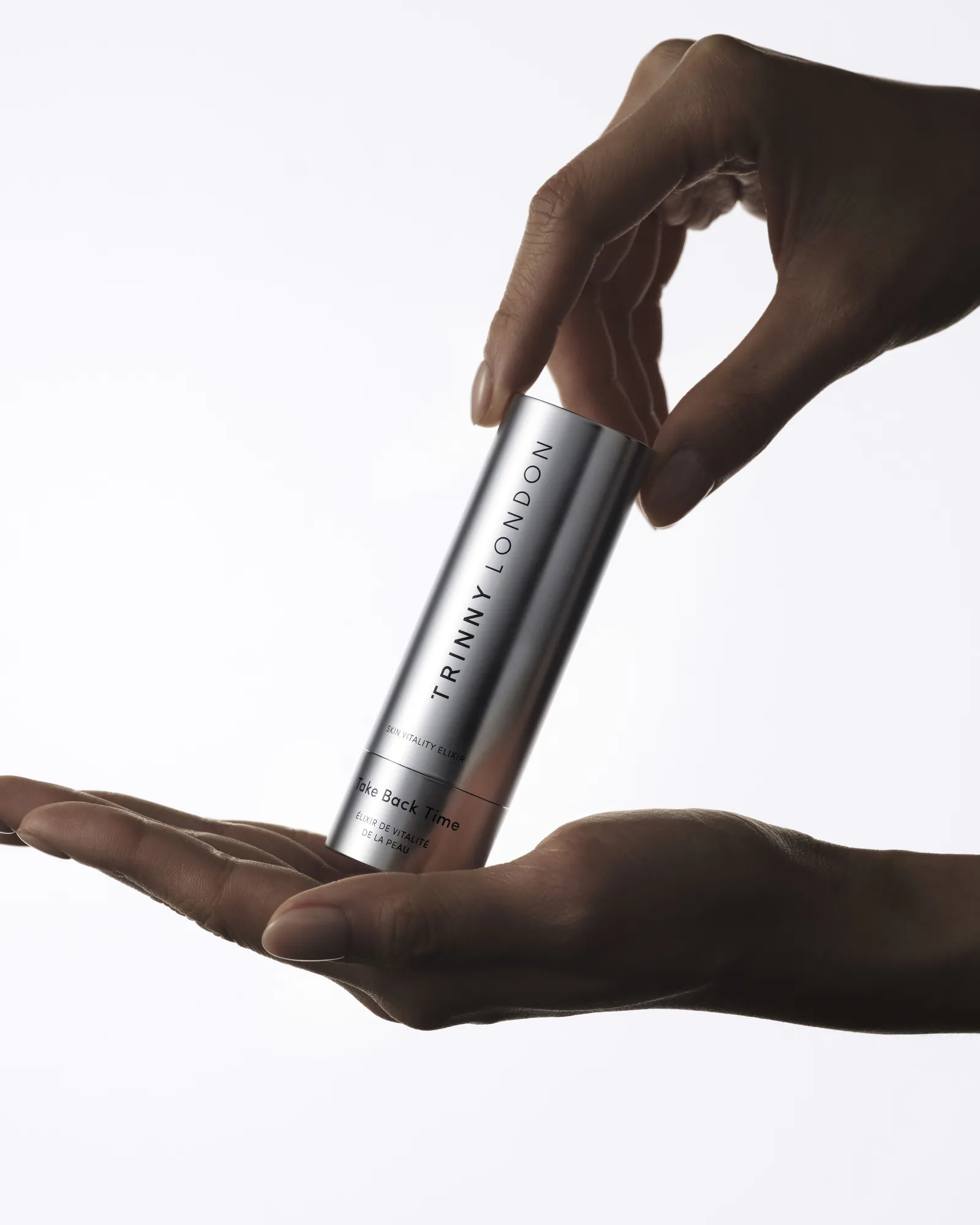 tl s10 elixir hand with product 287 v3a - product still life photography